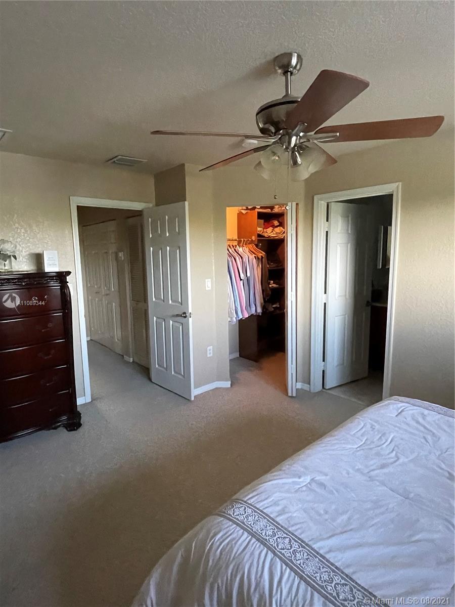 5924 Abbey Road Tamarac, FL 33321 - Photo 28 of 44 a bedroom with closet and rack