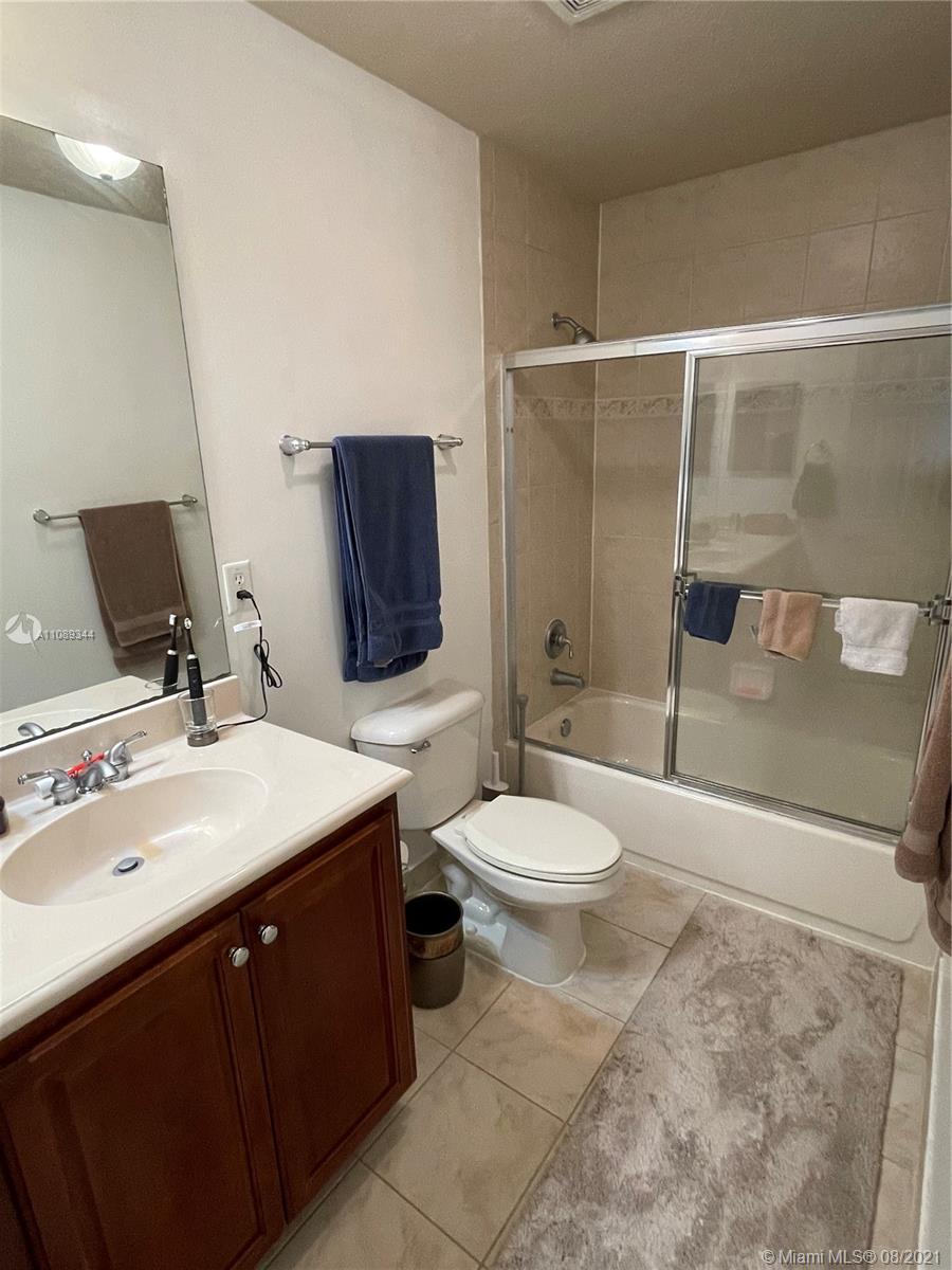 5924 Abbey Road Tamarac, FL 33321 - Photo 29 of 44 a bathroom with a toilet a sink and mirror