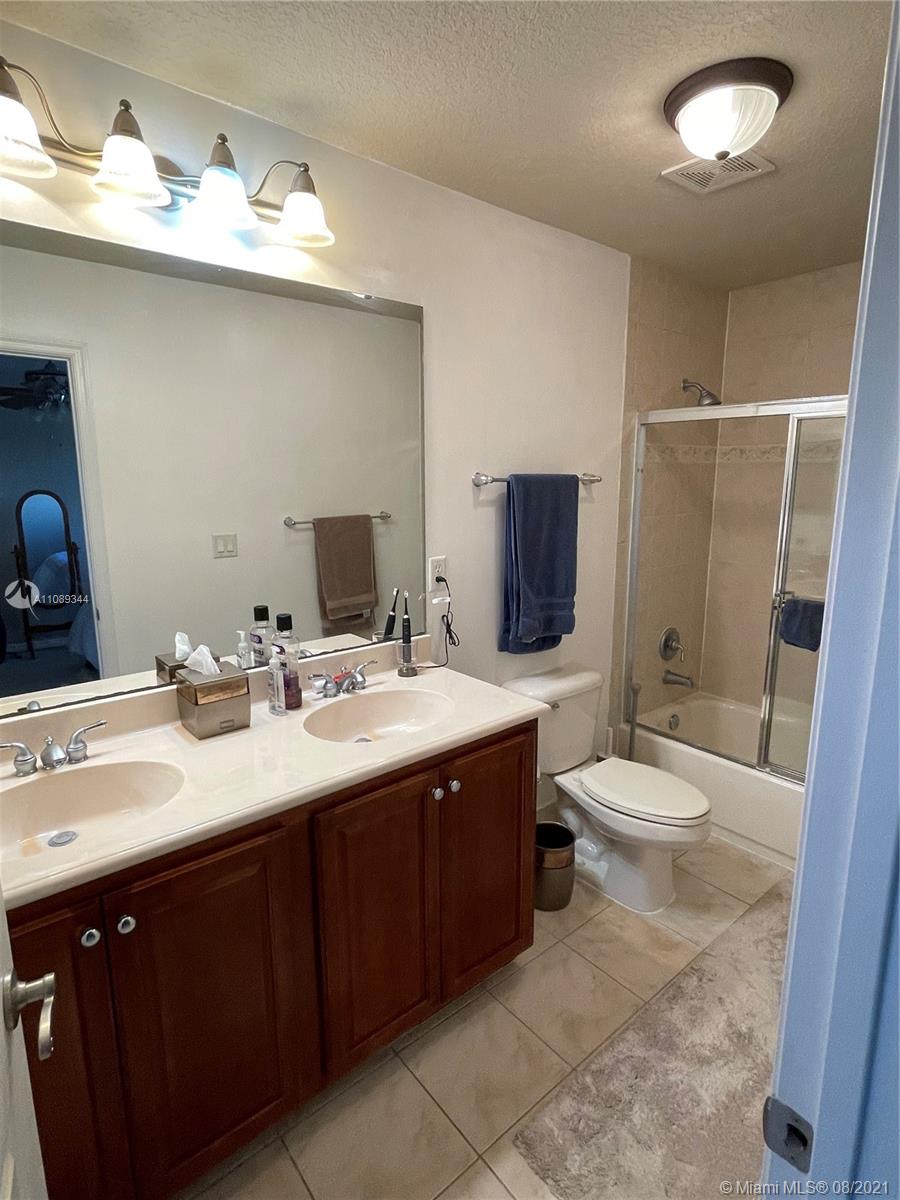 5924 Abbey Road Tamarac, FL 33321 - Photo 30 of 44 a bathroom with a double vanity sink toilet and shower