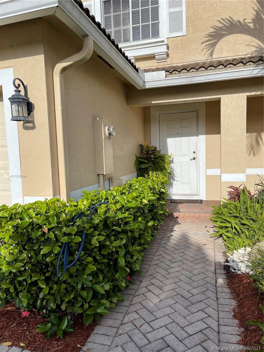 5924 Abbey Road Tamarac, FL 33321 - Photo 4 of 44 a front view of a house with garden
