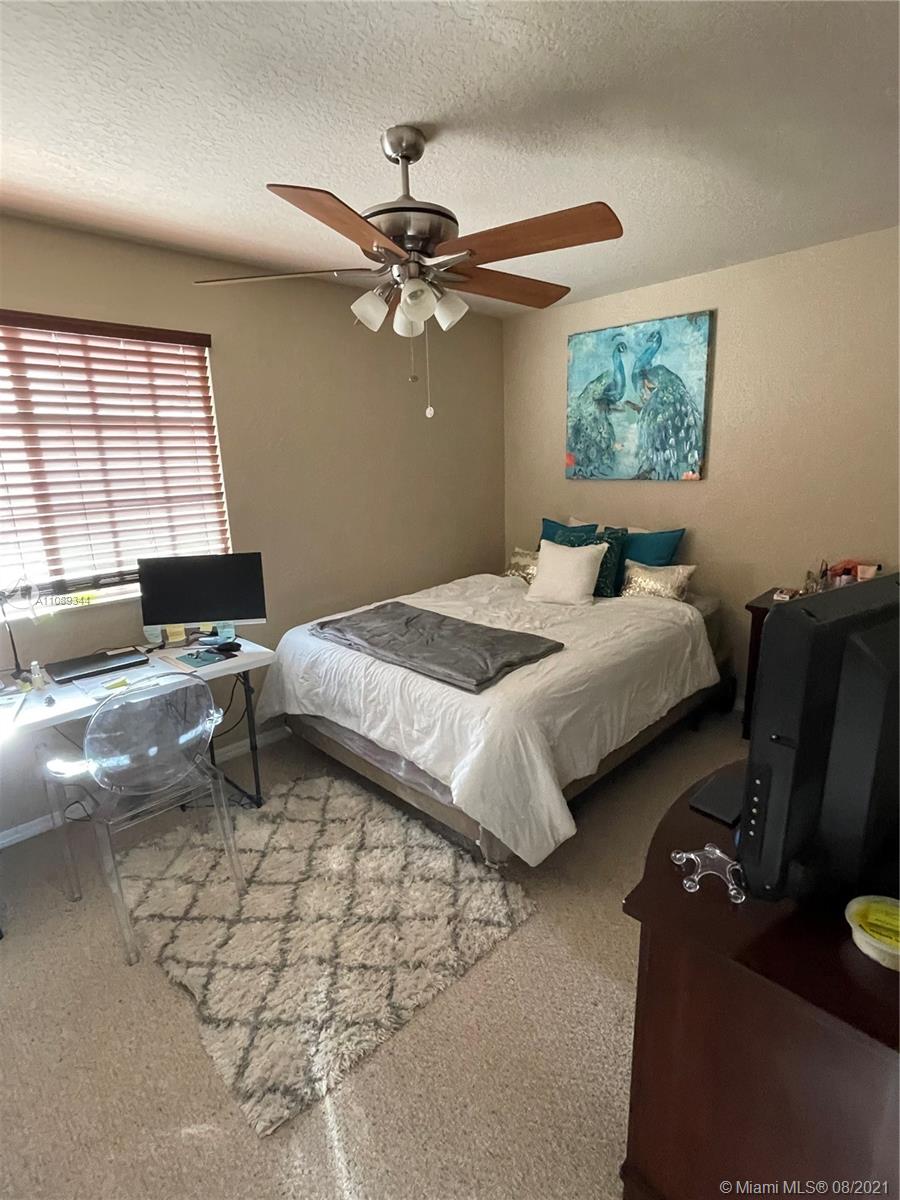 5924 Abbey Road Tamarac, FL 33321 - Photo 31 of 44 a bedroom with bed and window