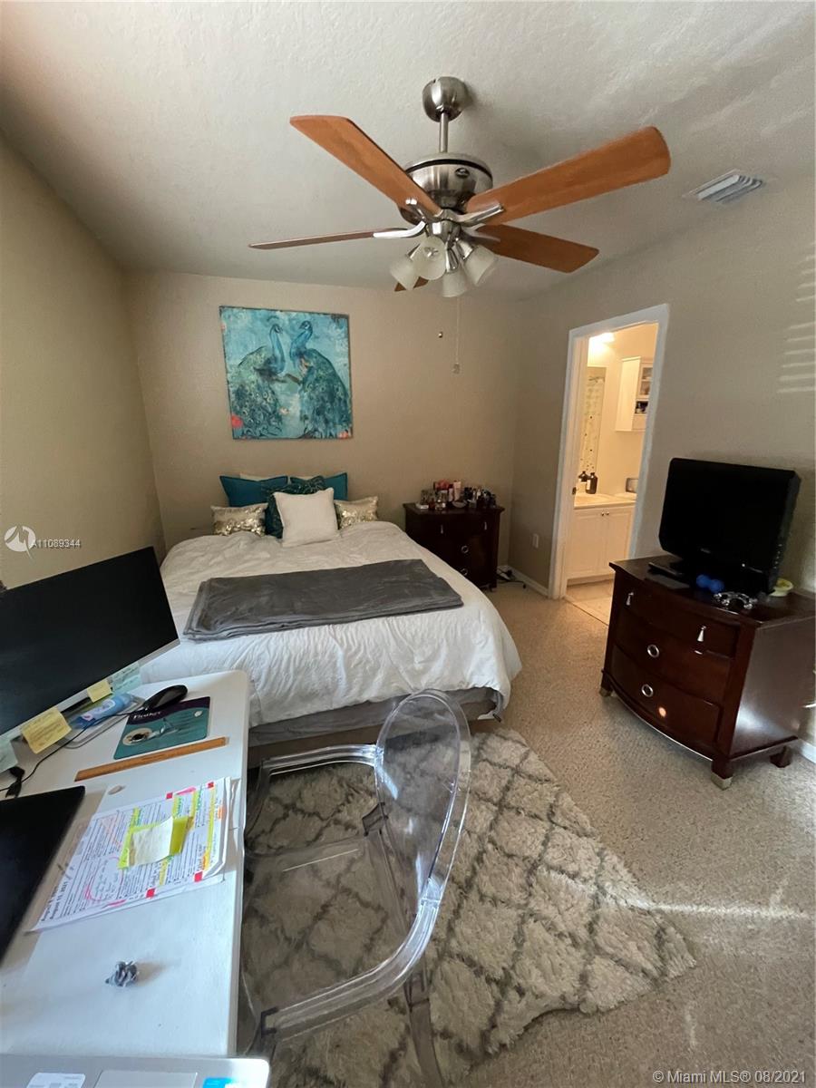 5924 Abbey Road Tamarac, FL 33321 - Photo 32 of 44 a bedroom with a bed and a tv