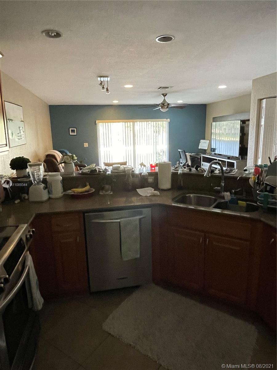 5924 Abbey Road Tamarac, FL 33321 - Photo 43 of 44 a kitchen with sink attached with living room