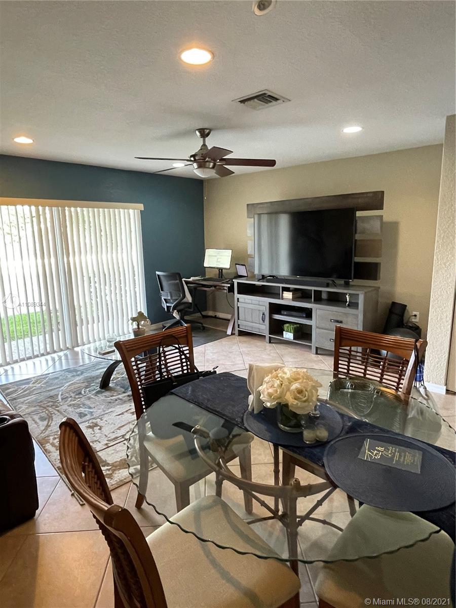 5924 Abbey Road Tamarac, FL 33321 - Photo 7 of 44 a living room with furniture and a flat screen tv