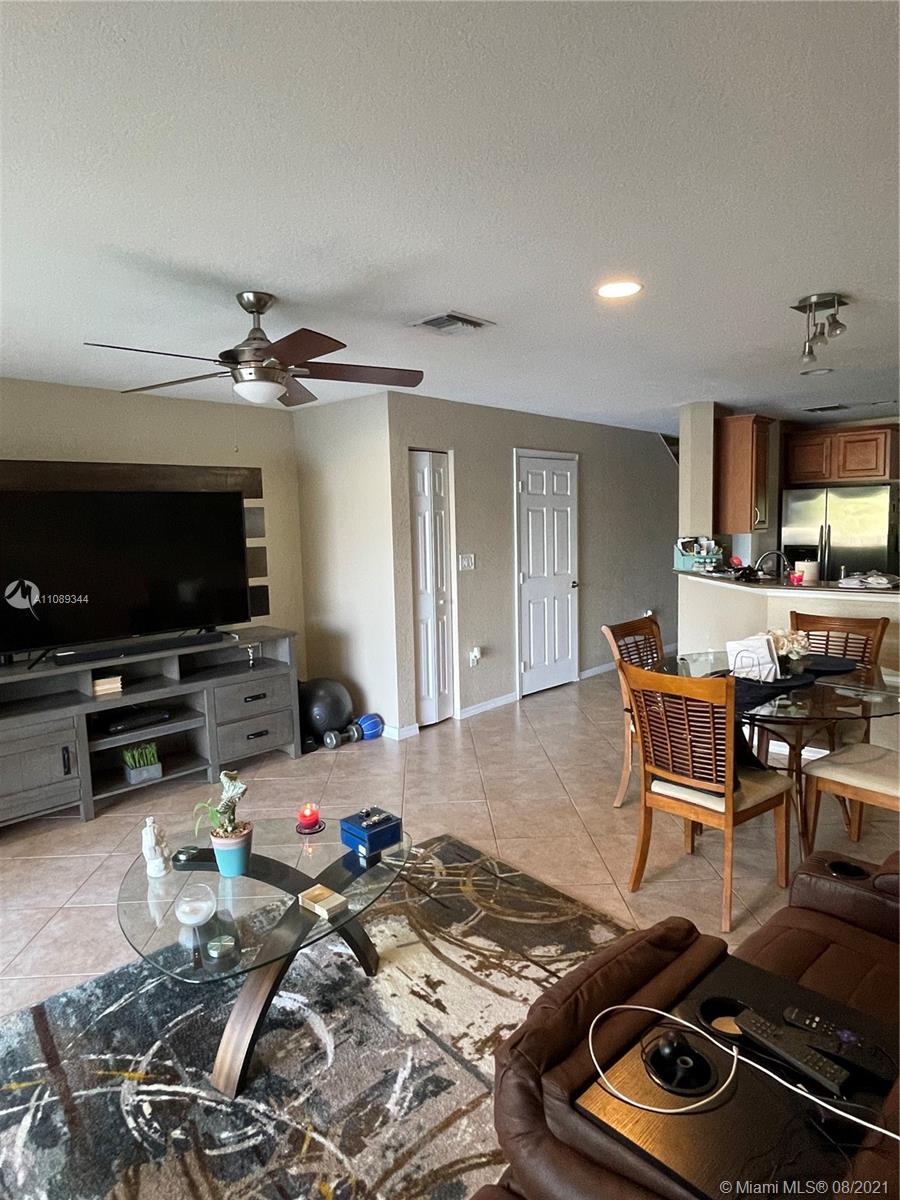 5924 Abbey Road Tamarac, FL 33321 - Photo 8 of 44 a living room with furniture and a flat screen tv
