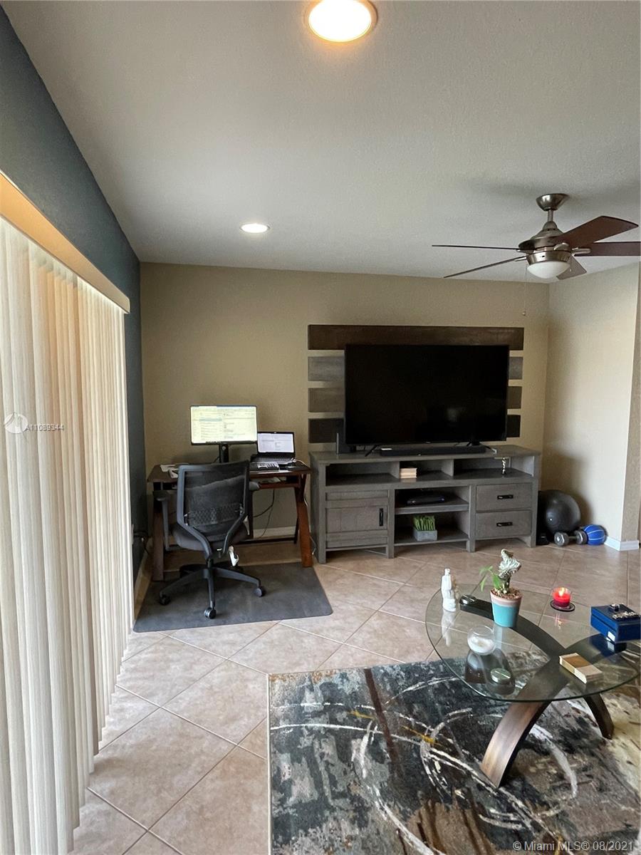 5924 Abbey Road Tamarac, FL 33321 - Photo 9 of 44 a living room with furniture and a flat screen tv