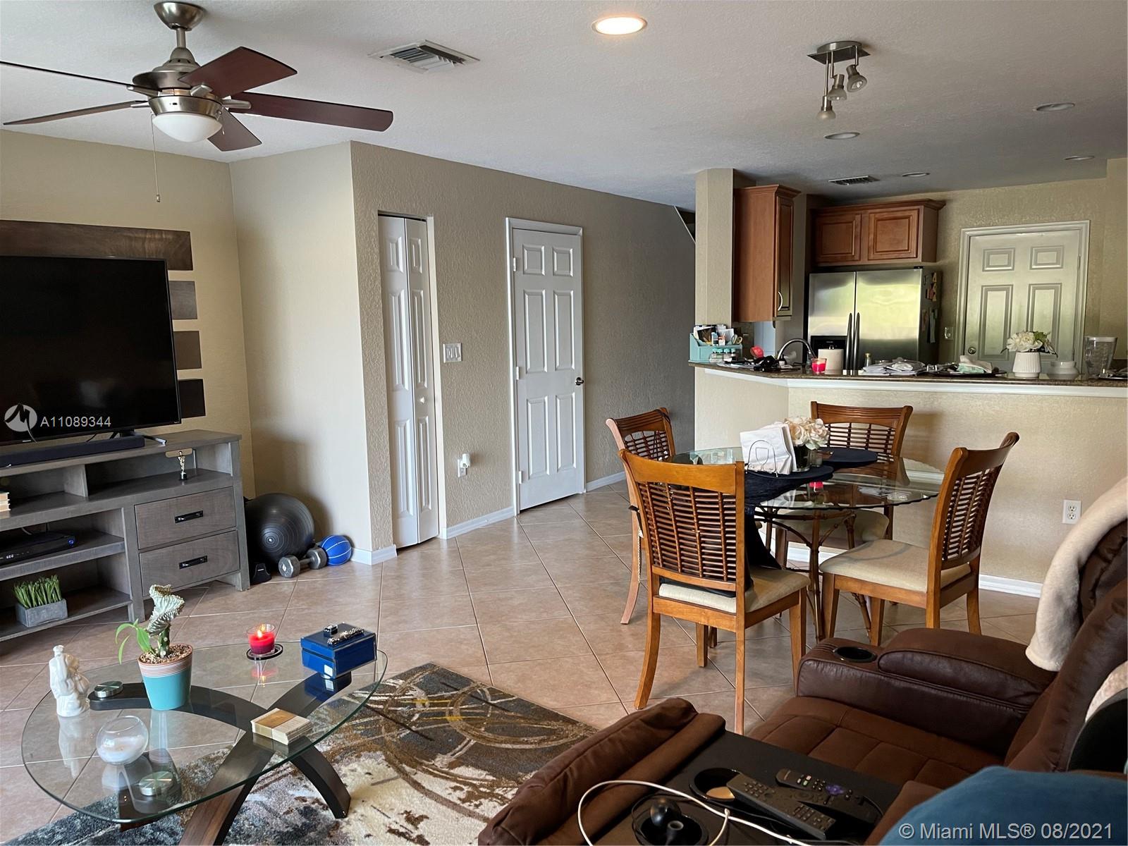 5924 Abbey Road Tamarac, FL 33321 - Photo 10 of 44 a living room with furniture and a flat screen tv