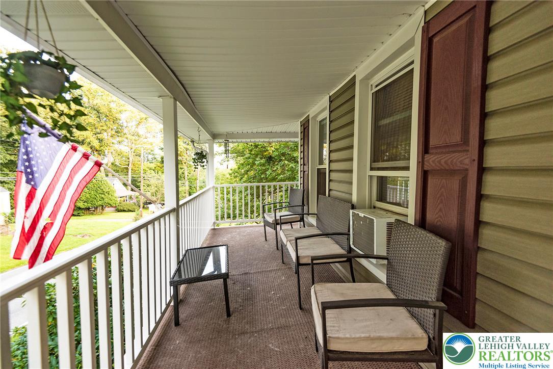 1114 Fox Gap Road Bangor, PA 18013 - Photo 11 of 63 An inviting covered porch wraps along the side of the home with clean siding details.