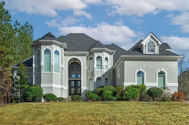a front view of a house with garden