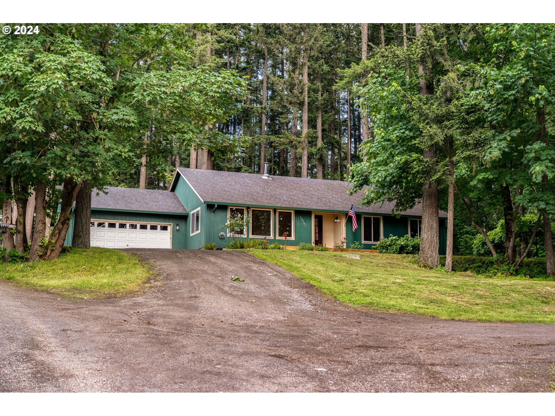 24741 South Central Point Road Canby, OR 97013 - Photo 3 of 48 a front view of a house with a garden