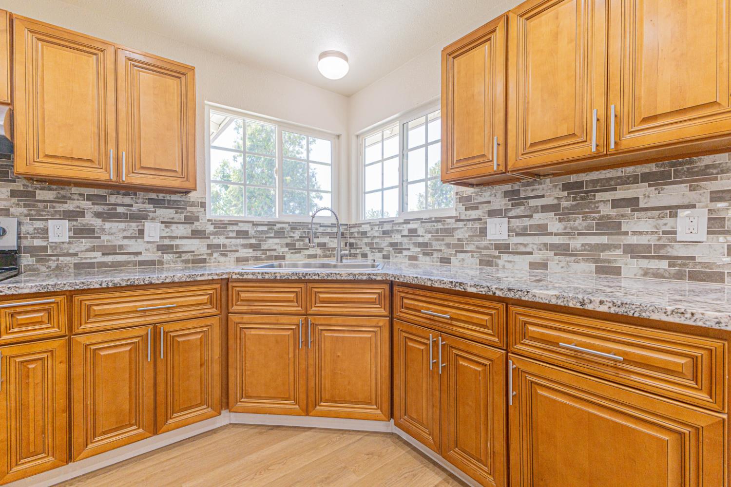 17925 Rodeo Drive Madera, CA 93638 - Photo 8 of 26 a kitchen with stainless steel appliances granite countertop white cabinets sink and dishwasher