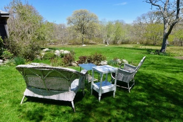 31 South Ridge Road Chilmark, MA 02535 - Photo 20 of 20 a view of a table and chairs in the garden