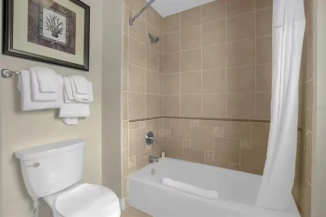 a bathroom with a toilet and a bathtub