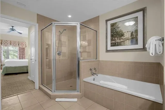 a bathroom with a tub shower and window