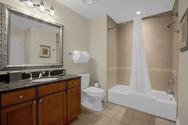 a bathroom with a double vanity sink mirror and toilet