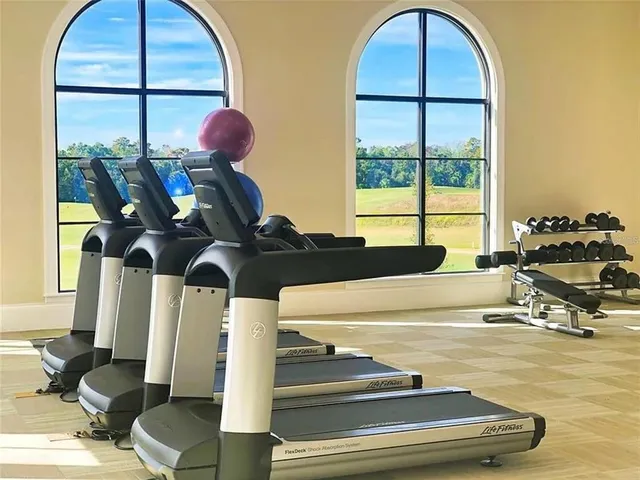a room with gym equipment and a large window