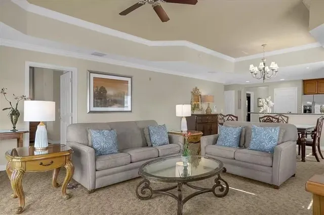 a living room with furniture and a chandelier