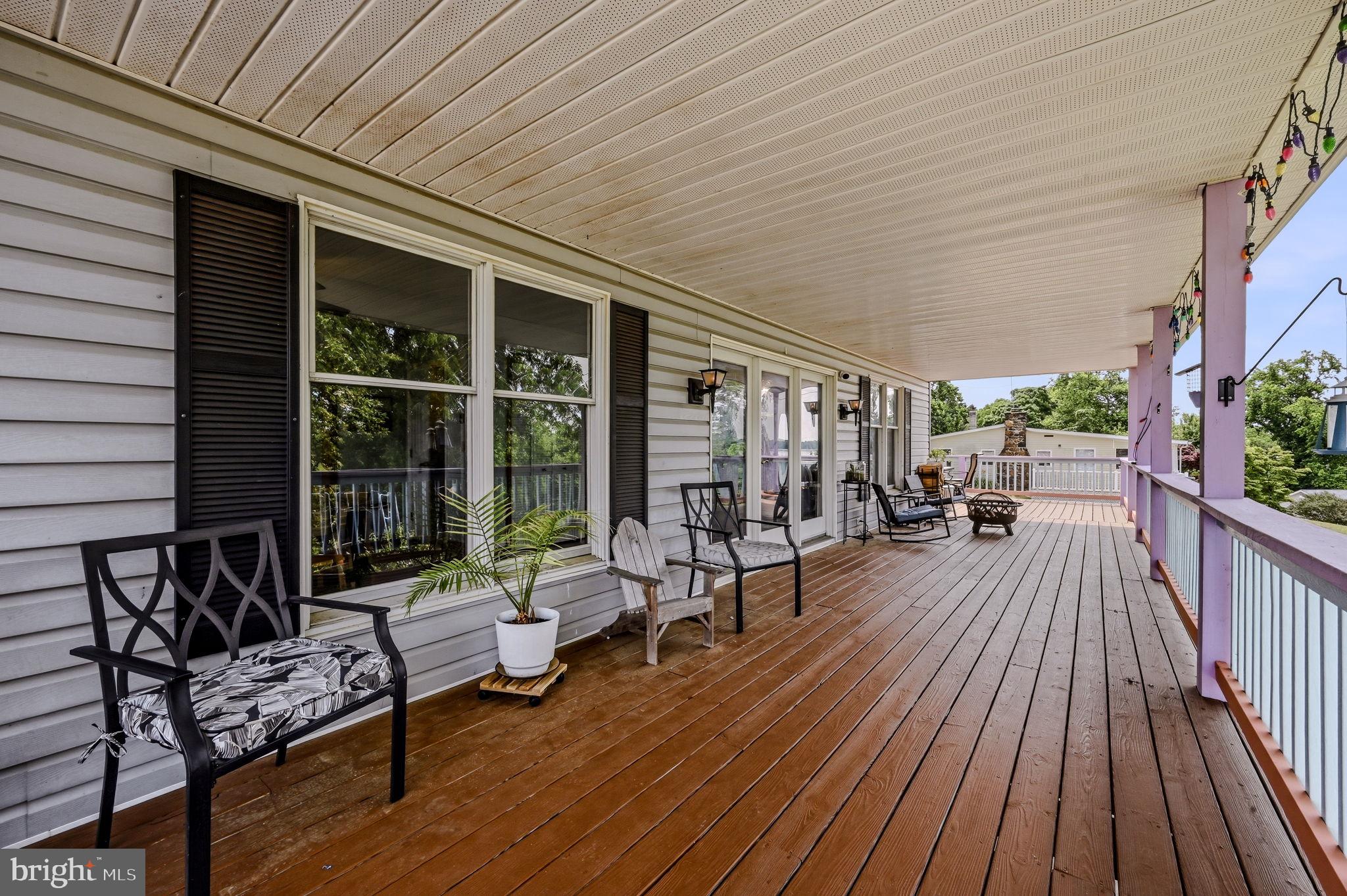 210 Elk View Road North East, MD 21901 - Photo 42 of 64 a view of a patio with table and chairs barbeque with wooden floor and fence