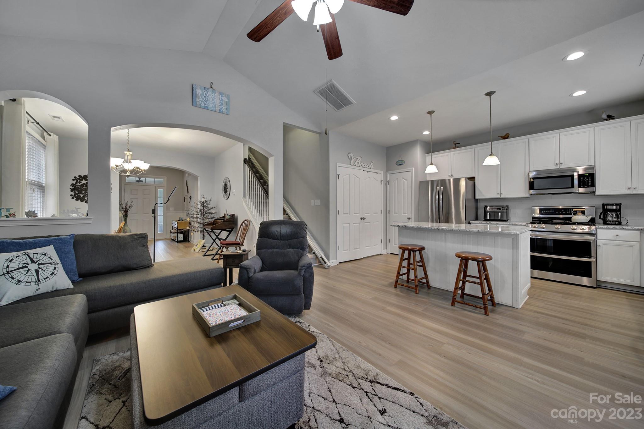 1079 Market Street Fort Mill, SC 29708 - Photo 13 of 46 a living room with furniture kitchen view and a wooden floor