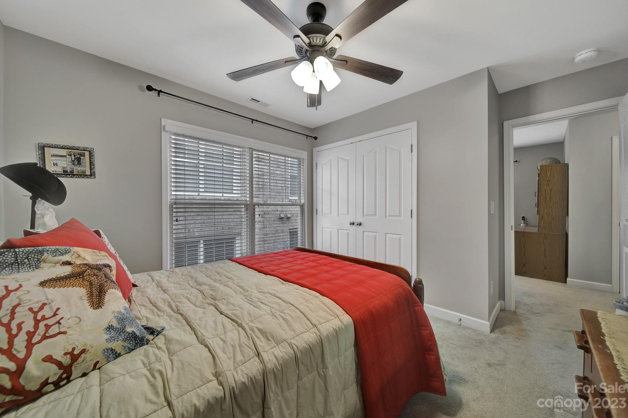1079 Market Street Fort Mill, SC 29708 - Photo 21 of 46 a bedroom with a bed and a chandelier