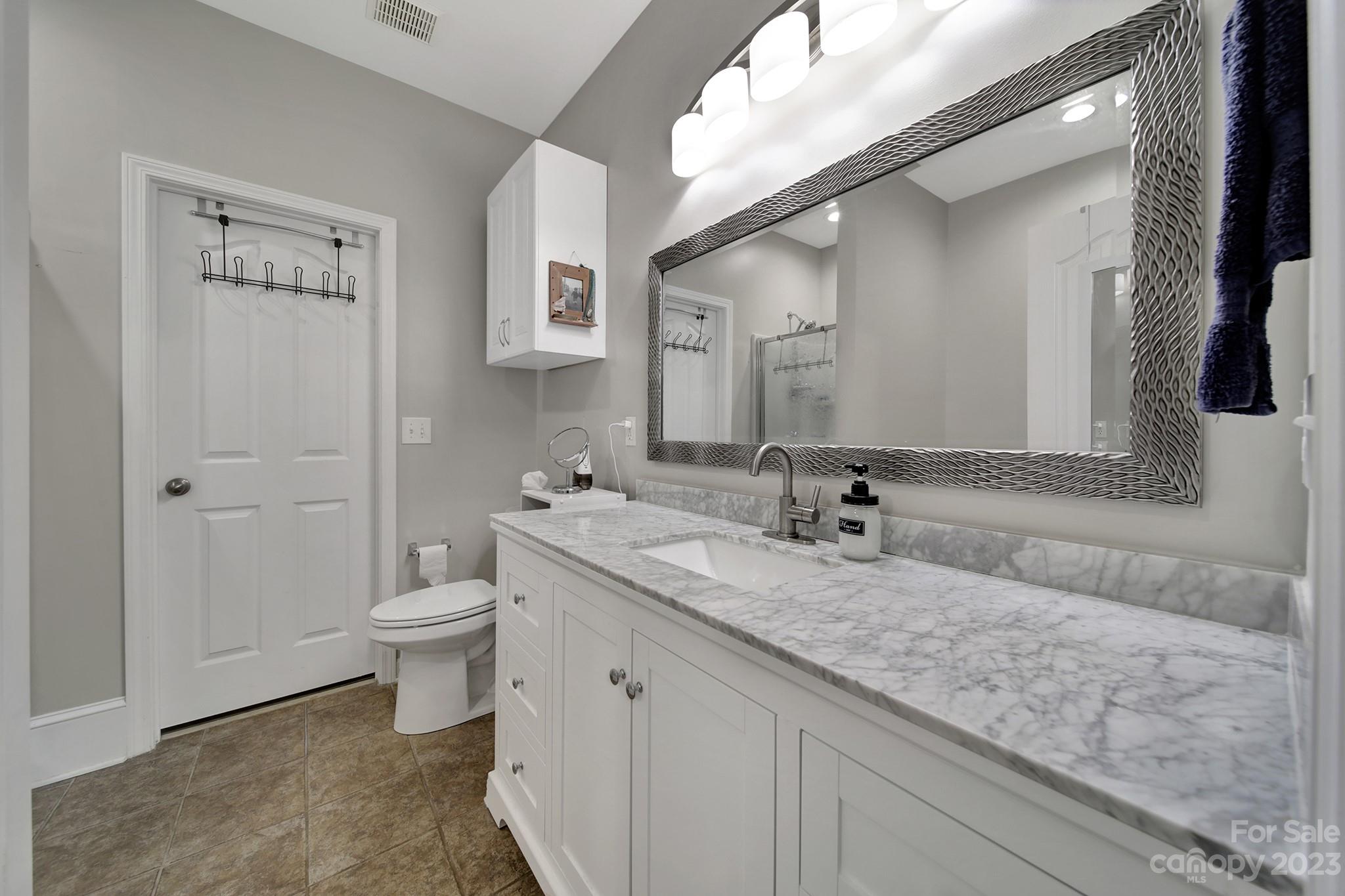 1079 Market Street Fort Mill, SC 29708 - Photo 8 of 46 a bathroom with a granite countertop sink and a mirror