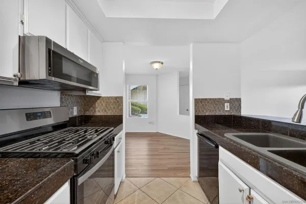 a kitchen that has a sink and a stove