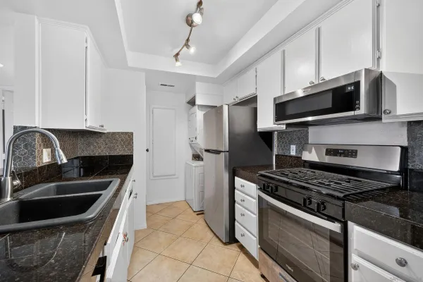 a kitchen with stainless steel appliances a stove a sink and a microwave