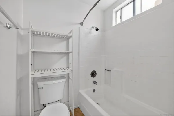 a bathroom with a toilet and a bathtub