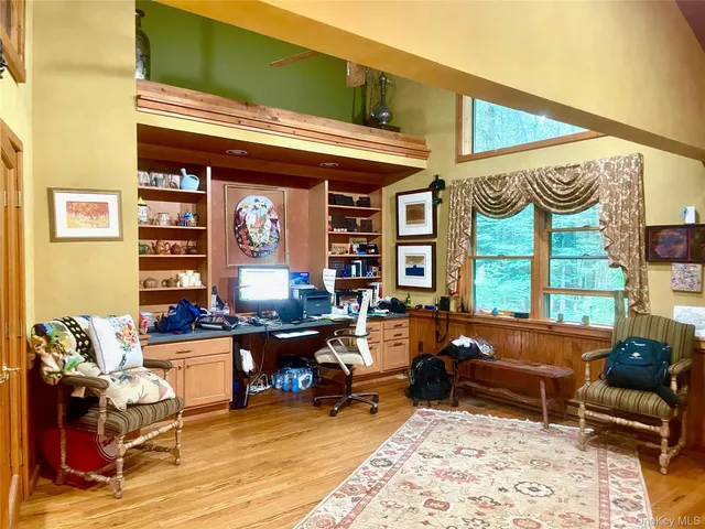 a living room with furniture a rug and a large window