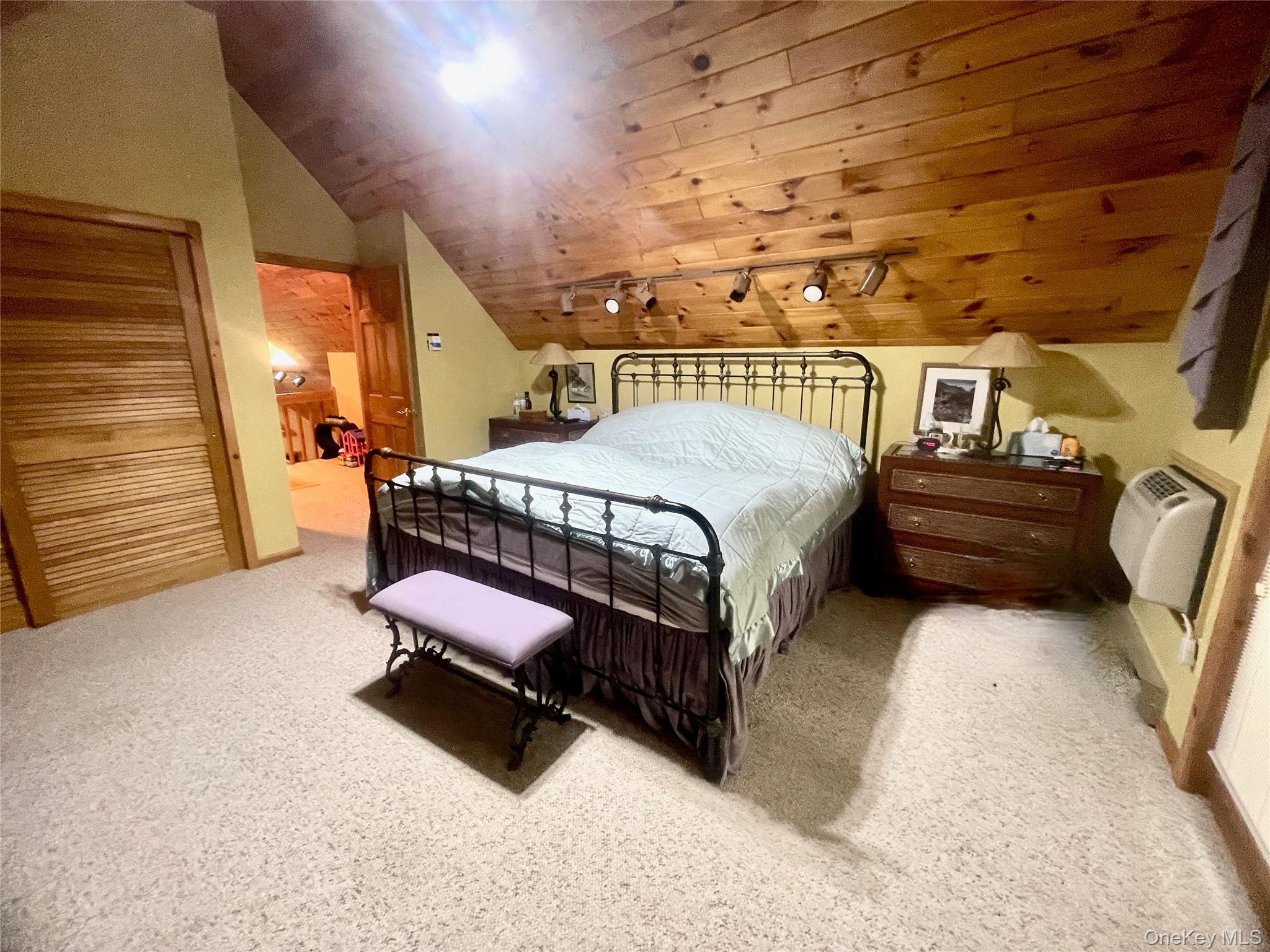 111 Deer Meadow Road Bethel, NY 12786 - Photo 17 of 43 a bedroom with a bed and wooden floor
