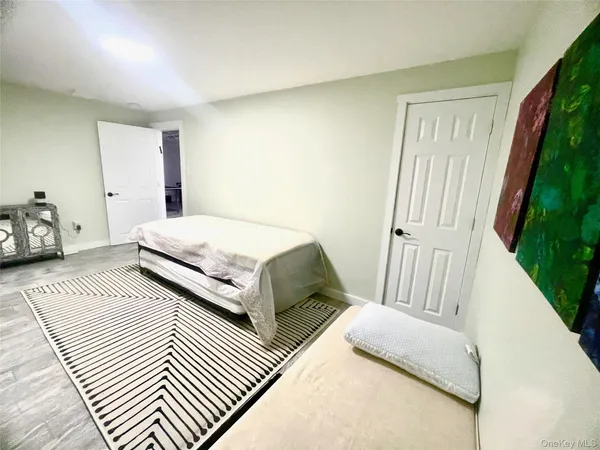 a bedroom with a bed and a couch