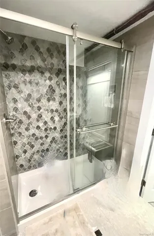 a bathroom with a bathtub and a shower