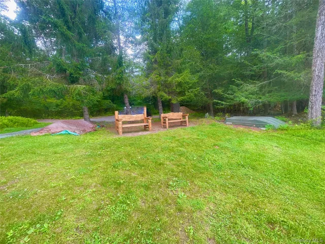 a view of a backyard with a bench