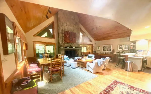 a living room with fireplace furniture and a large window