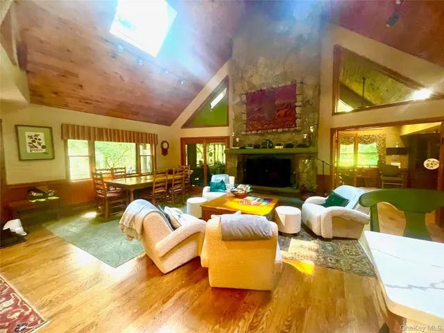 a living room with fireplace furniture and a large window