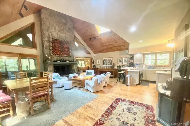 a living room with fireplace furniture and a large window