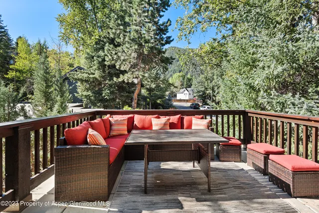 a balcony with wooden floor and furniture