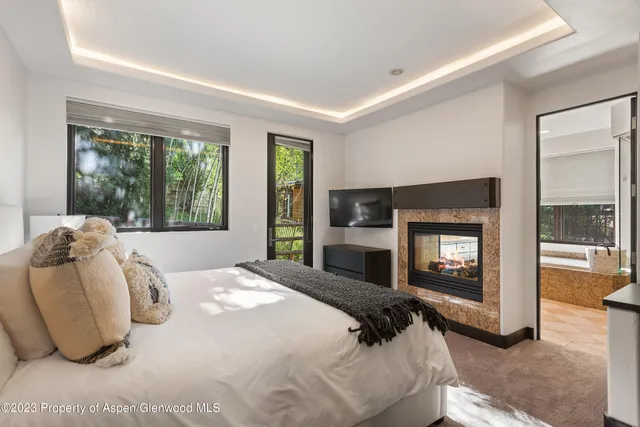 a bedroom with a bed and a television