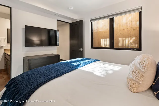 a spacious bathroom with a tub sink and mirror