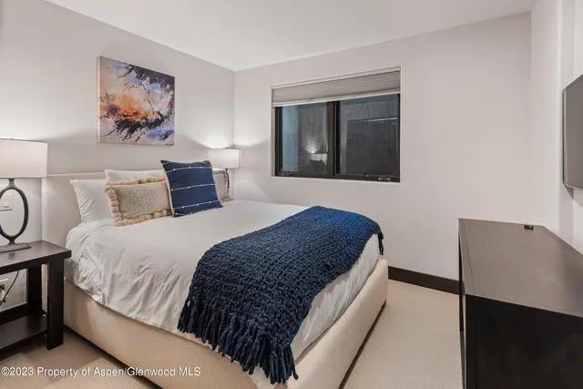 a bathroom with a granite countertop sink a toilet a mirror a bathtub and shower