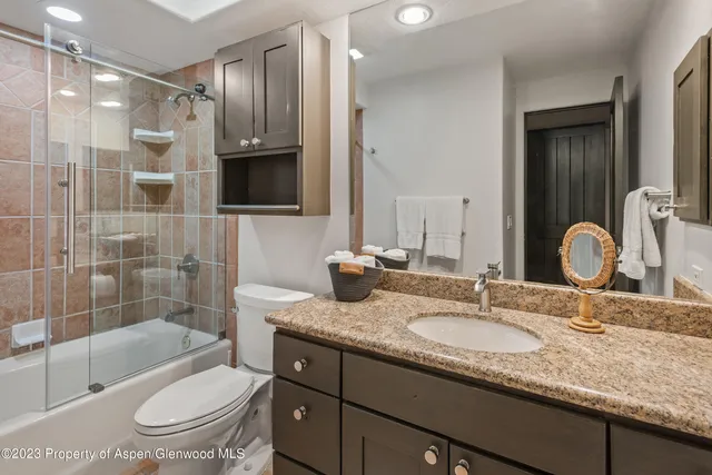 a kitchen with granite countertop a sink and a refrigerator