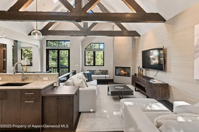 a kitchen with stainless steel appliances granite countertop a sink a stove and a wooden cabinets