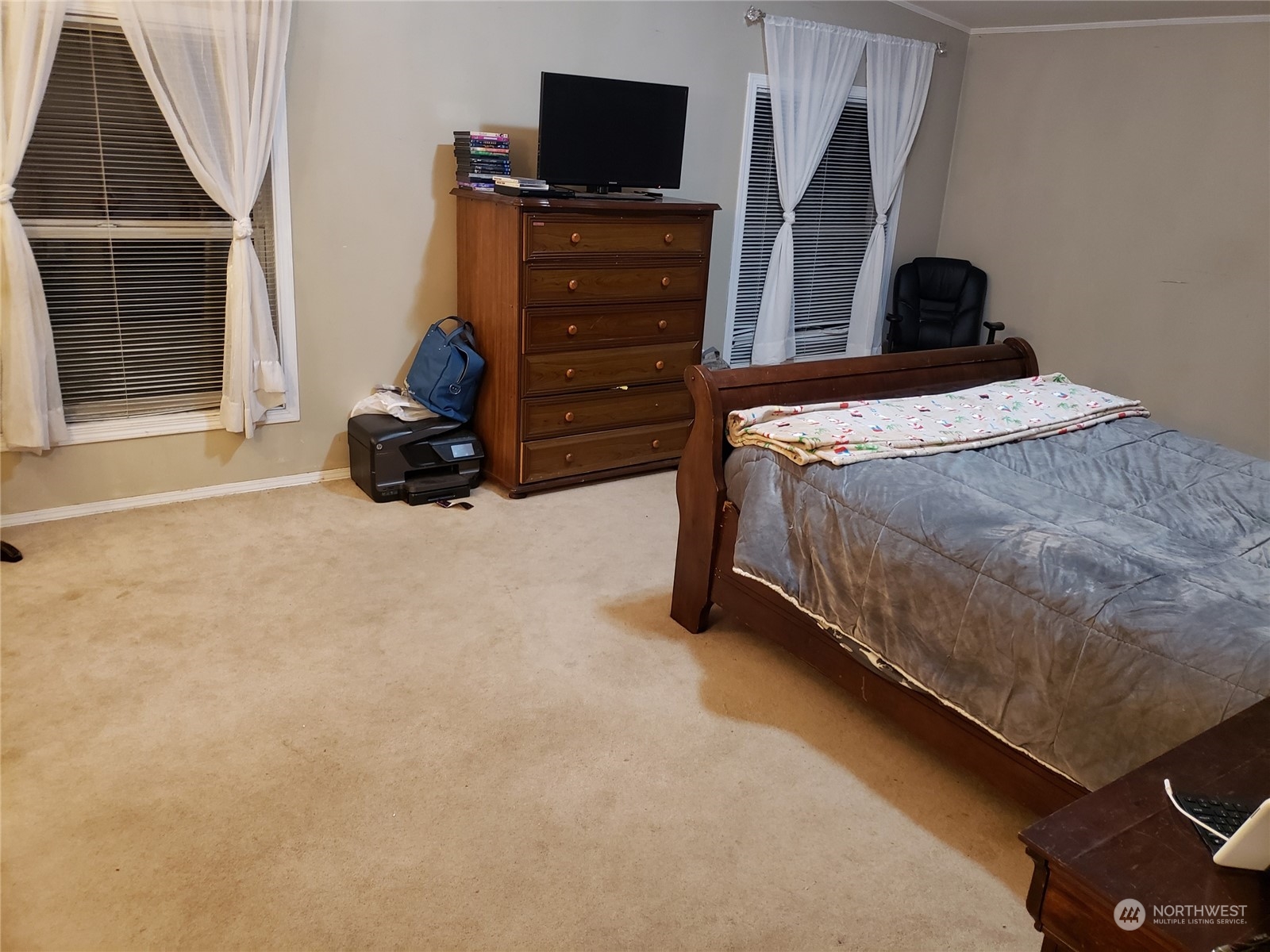 7130 196th Avenue Southwest Rochester, WA 98579 - Photo 11 of 36 a bedroom with a bed and a flat tv screen on dresser