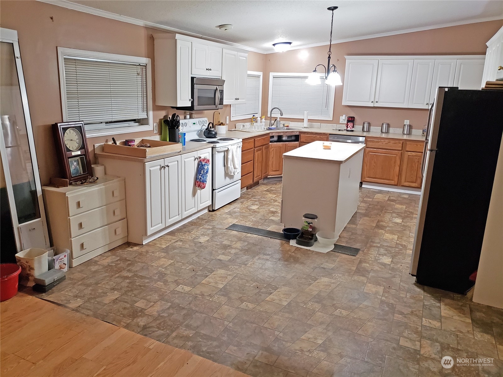 7130 196th Avenue Southwest Rochester, WA 98579 - Photo 17 of 36 a kitchen with cabinets a sink a stove a refrigerator and chairs