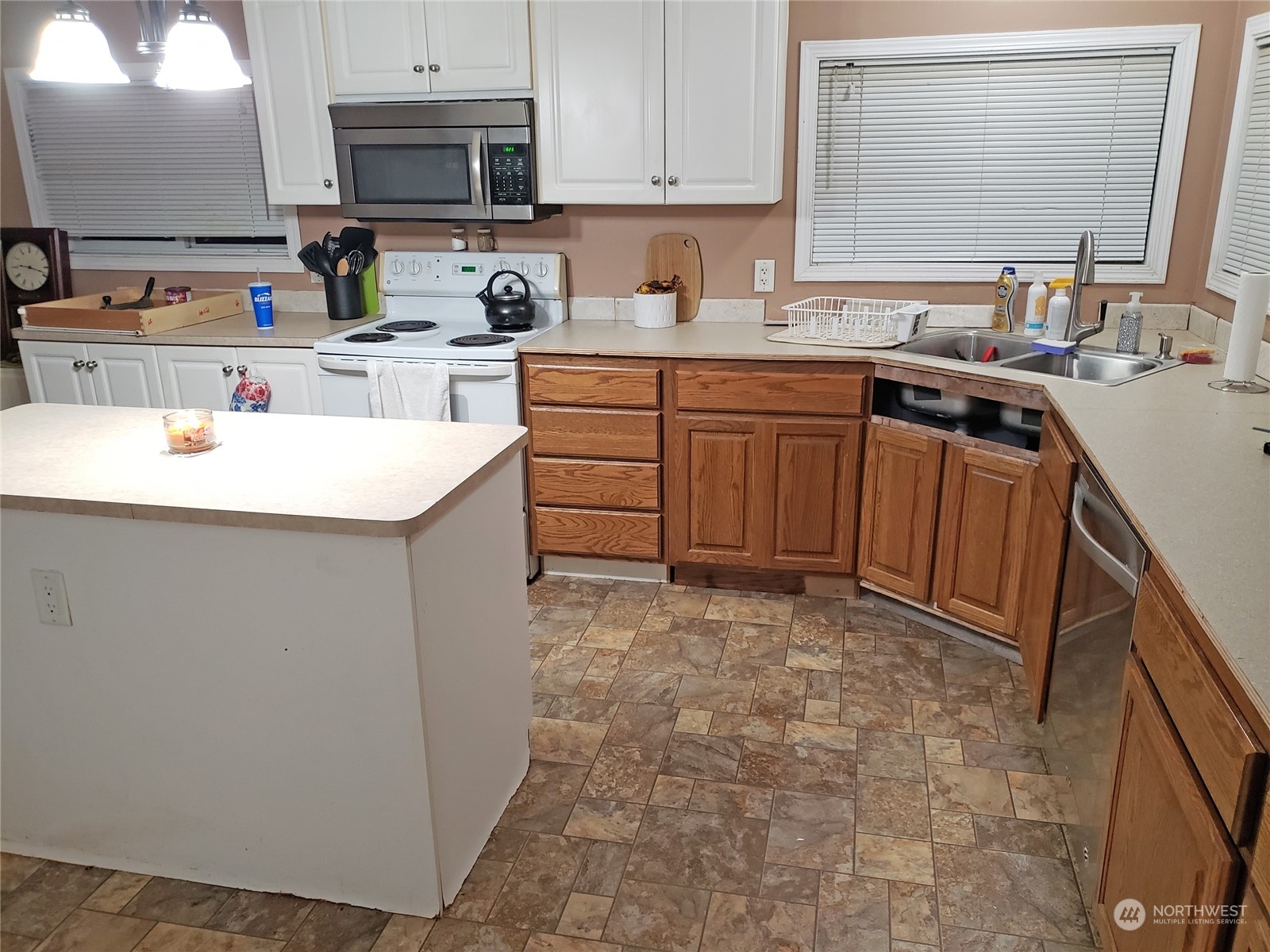 7130 196th Avenue Southwest Rochester, WA 98579 - Photo 20 of 36 a kitchen with stainless steel appliances a sink a stove a microwave a sink a refrigerator and dishwasher