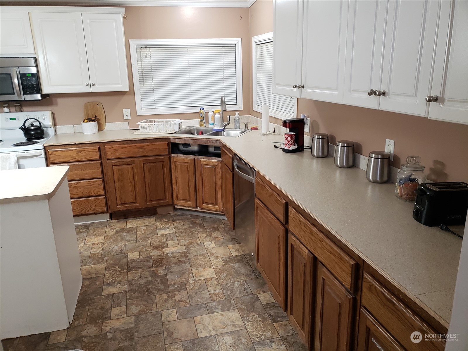 7130 196th Avenue Southwest Rochester, WA 98579 - Photo 23 of 36 a kitchen with a sink stove and cabinets