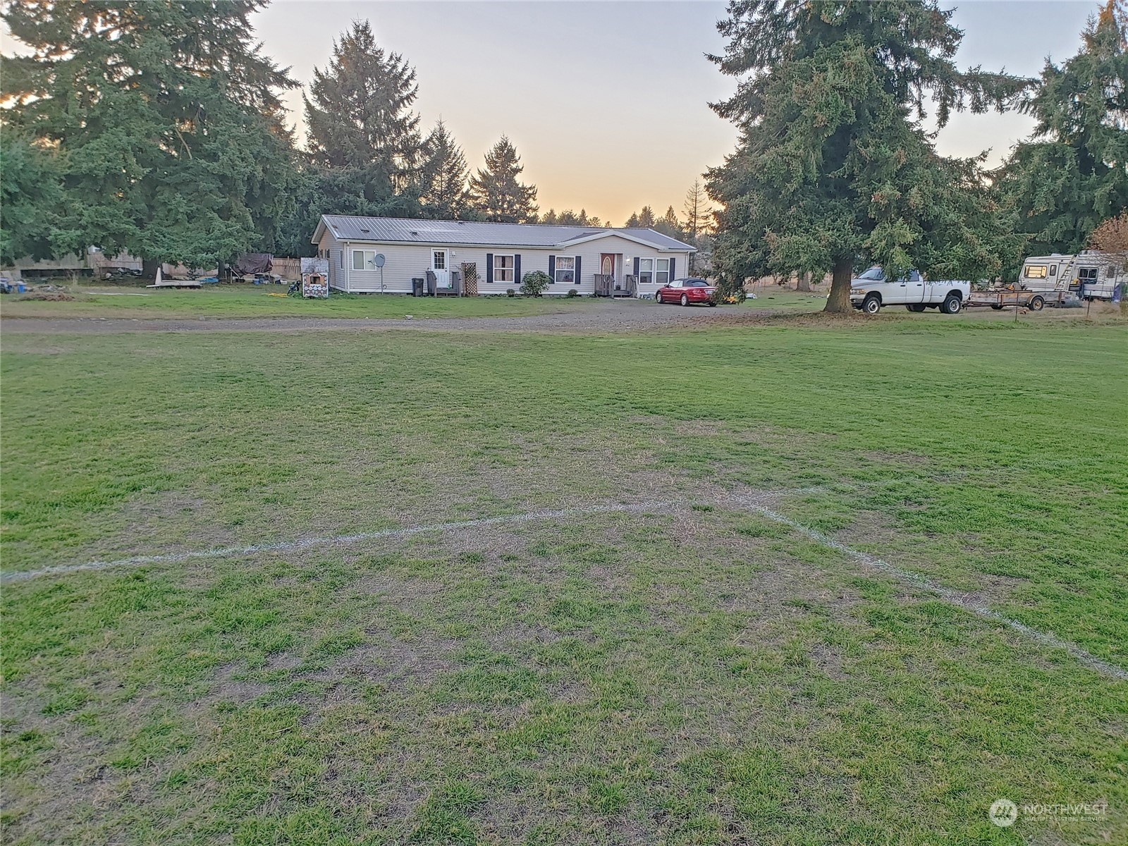 7130 196th Avenue Southwest Rochester, WA 98579 - Photo 27 of 36 a view of a street with a building and trees in the background