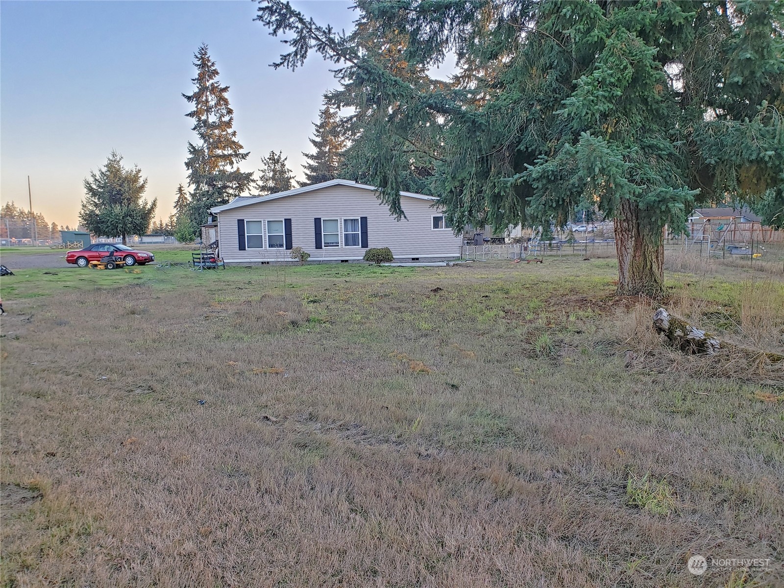 7130 196th Avenue Southwest Rochester, WA 98579 - Photo 29 of 36 a view of a house with a yard and tree s