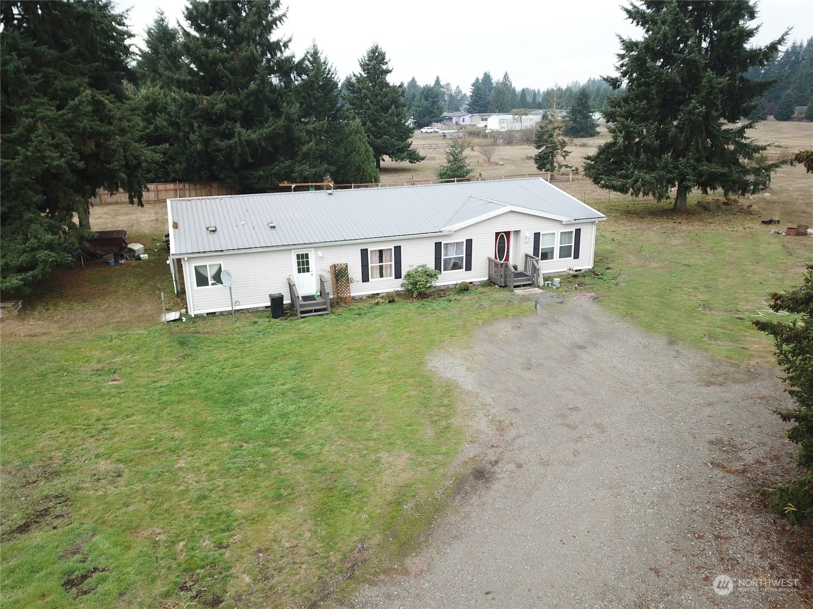 7130 196th Avenue Southwest Rochester, WA 98579 - Photo 3 of 36 an aerial view of residential houses with outdoor space and trees around