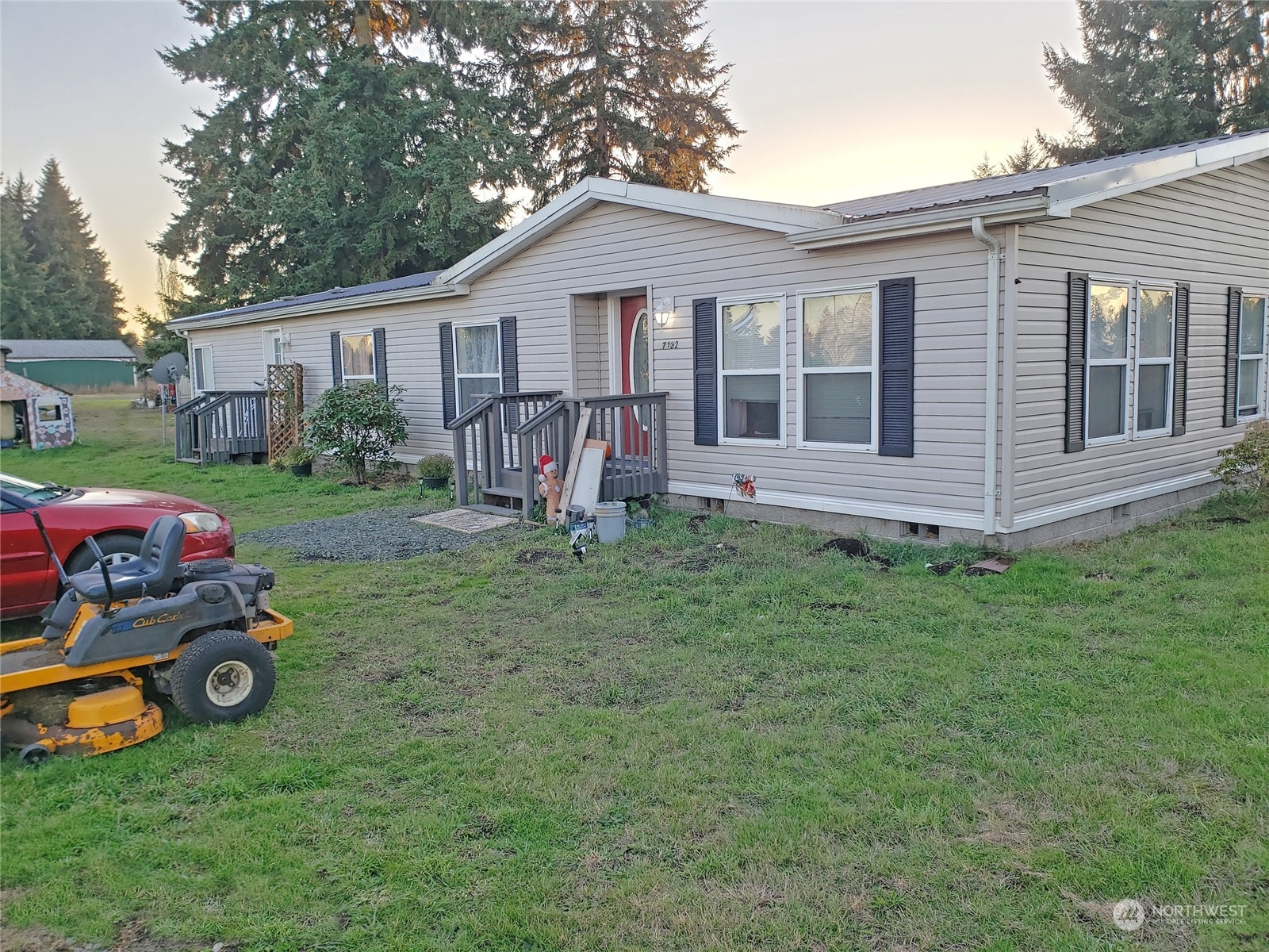 7130 196th Avenue Southwest Rochester, WA 98579 - Photo 4 of 36 a view of a house with a backyard and a car parked